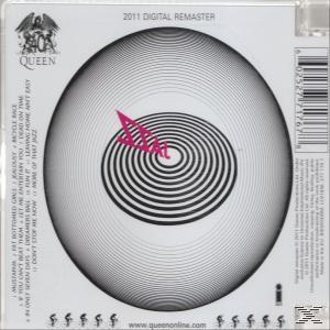 CD-Cover, weißer Hintergrund, schwarze konzentrische Kreise, rosa Dreieck. Text: 2011 Digital Remaster, Queen.