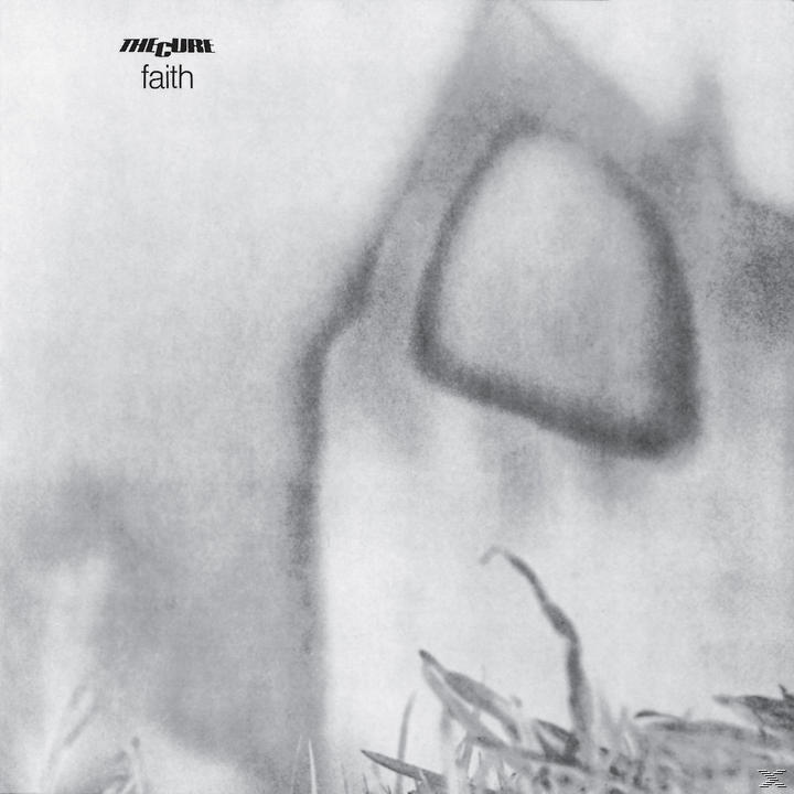 Albumcover für The Cure Faith, ein verschwommenes monochromatisches Bild. Der Titel befindet sich in der oberen linken Ecke. Gras im Vordergrund.