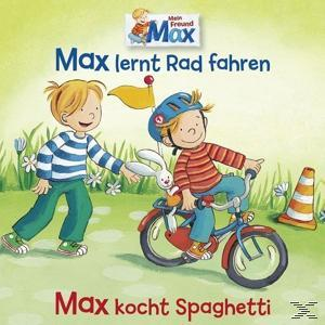 Zwei Kinder, eines auf einem Fahrrad mit einem Hasen, das andere geht. Das Fahrrad steht in der Nähe eines Verkehrskegels.