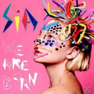 Albumcover: eine Frau mit Gesichtsbemalung und bunten Haaren. Albumtitel 'We Are Born' links.