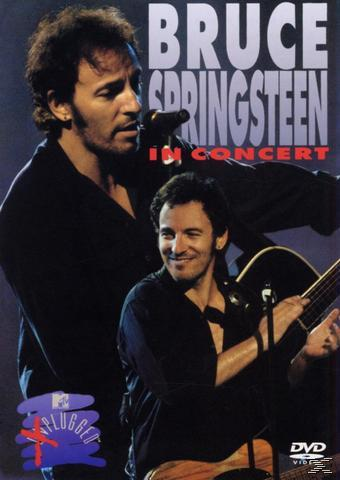 Bruce Springsteen im Konzert. Er spielt Gitarre und singt. Das Cover ist rot und blau.