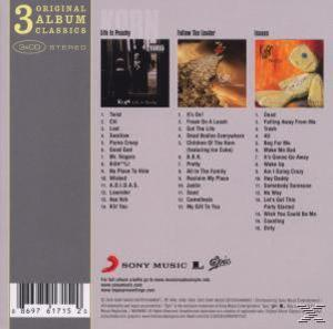 Albumcover. Korn's 3 Album-Klassiker. Titellisten an der Seite und Albumkunst in der Mitte.