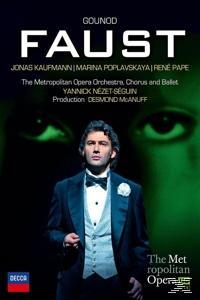 DVD-Cover für die Oper Faust. Ein Mann in formeller Kleidung steht vor grünem Hintergrund. Text enthält Namen und Operninfo.