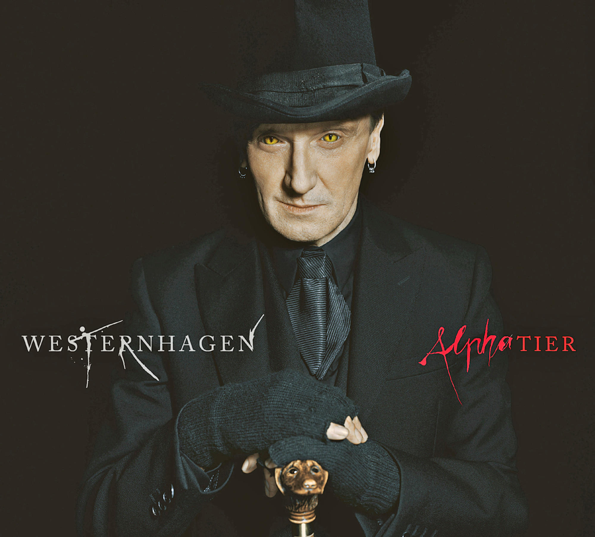 Mann im schwarzen Anzug mit Zylinder. Text: Westernhagen und Alphatier in Rot.