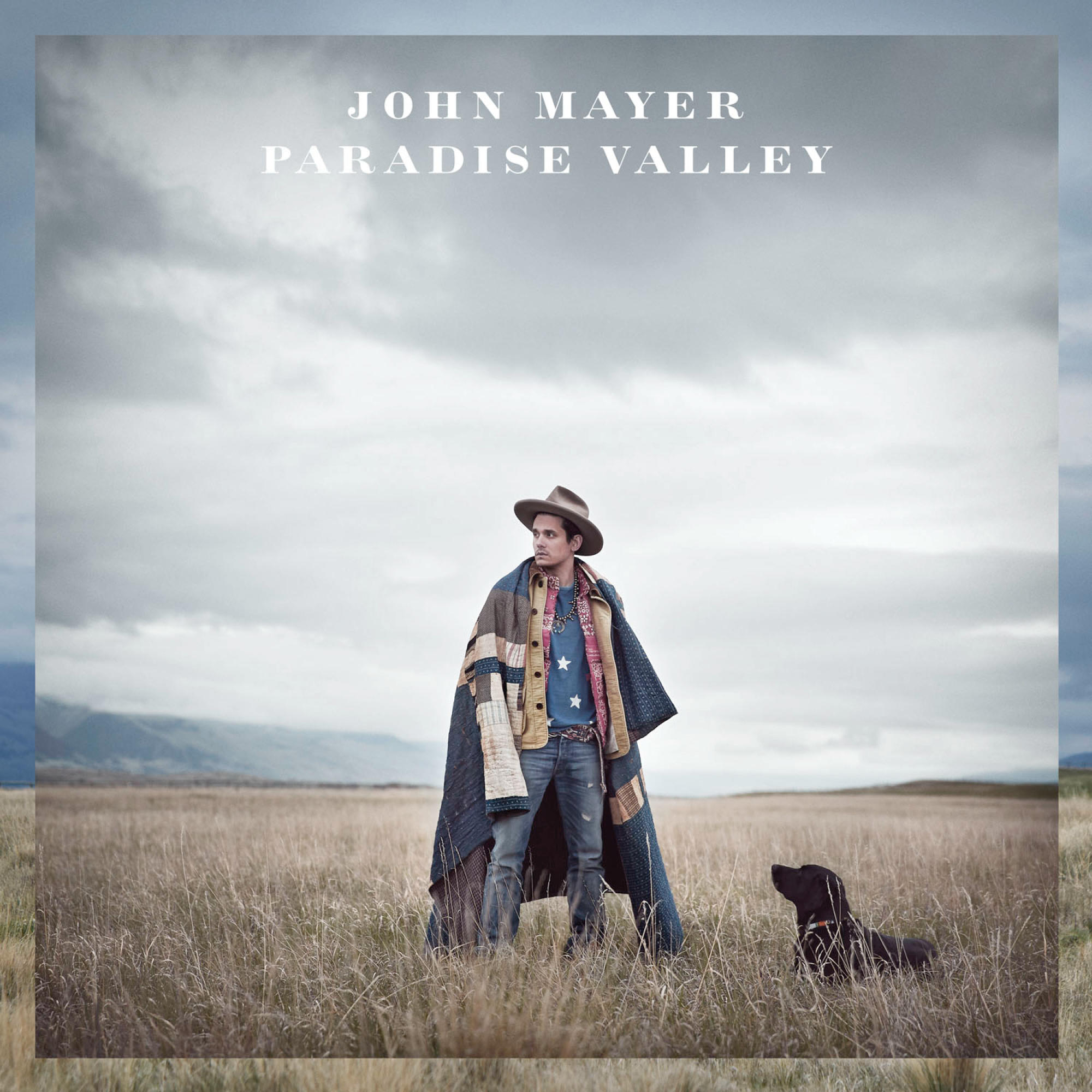 Albumcover. John Mayer auf einem Feld mit einem Hund. Bewölkter Himmel. Text: 'JOHN MAYER PARADISE VALLEY'.