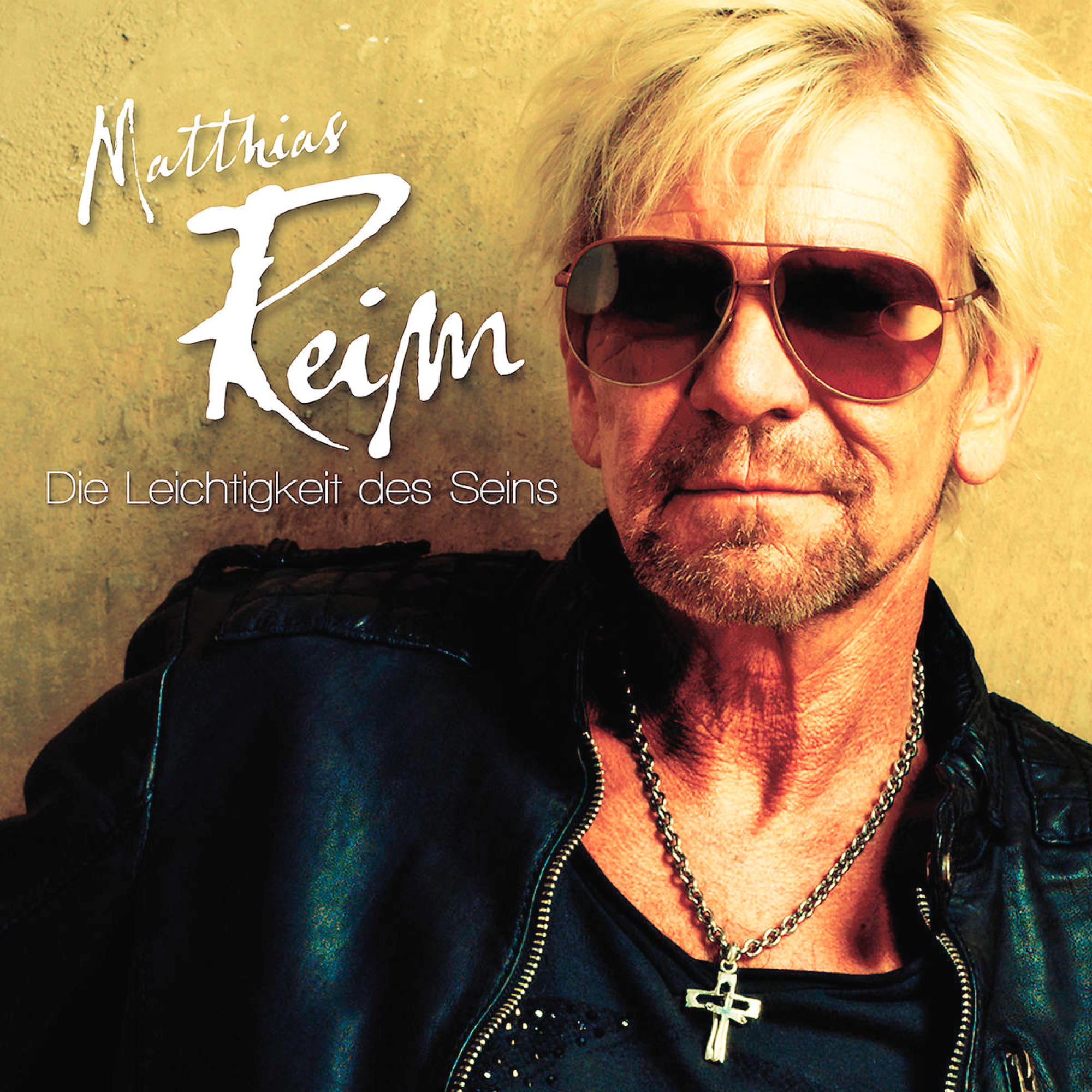 Matthias Reim Albumcover. Mann mit Sonnenbrille und Kreuzkette.