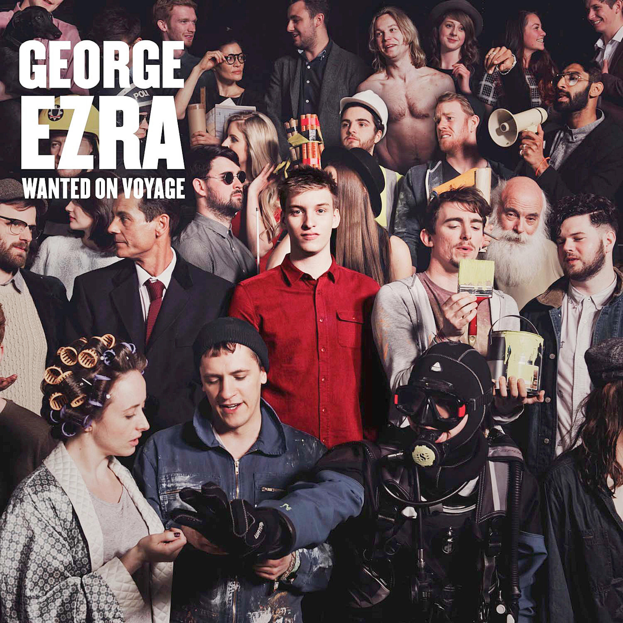 Albumcover: Gruppe von Menschen. Ein Mann in einem roten Hemd steht im Mittelpunkt. Text: 'George Ezra Wanted on Voyage'.
