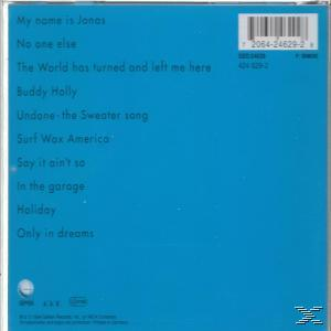 Rückseite des Albums. Titelliste auf blauem Hintergrund. Weißer Text. Barcode oben.