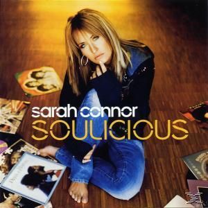 Sarah Connor Albumcover: Frau sitzt, blond, Albumtitel 'Soulicious', umgeben von Albumcovern.