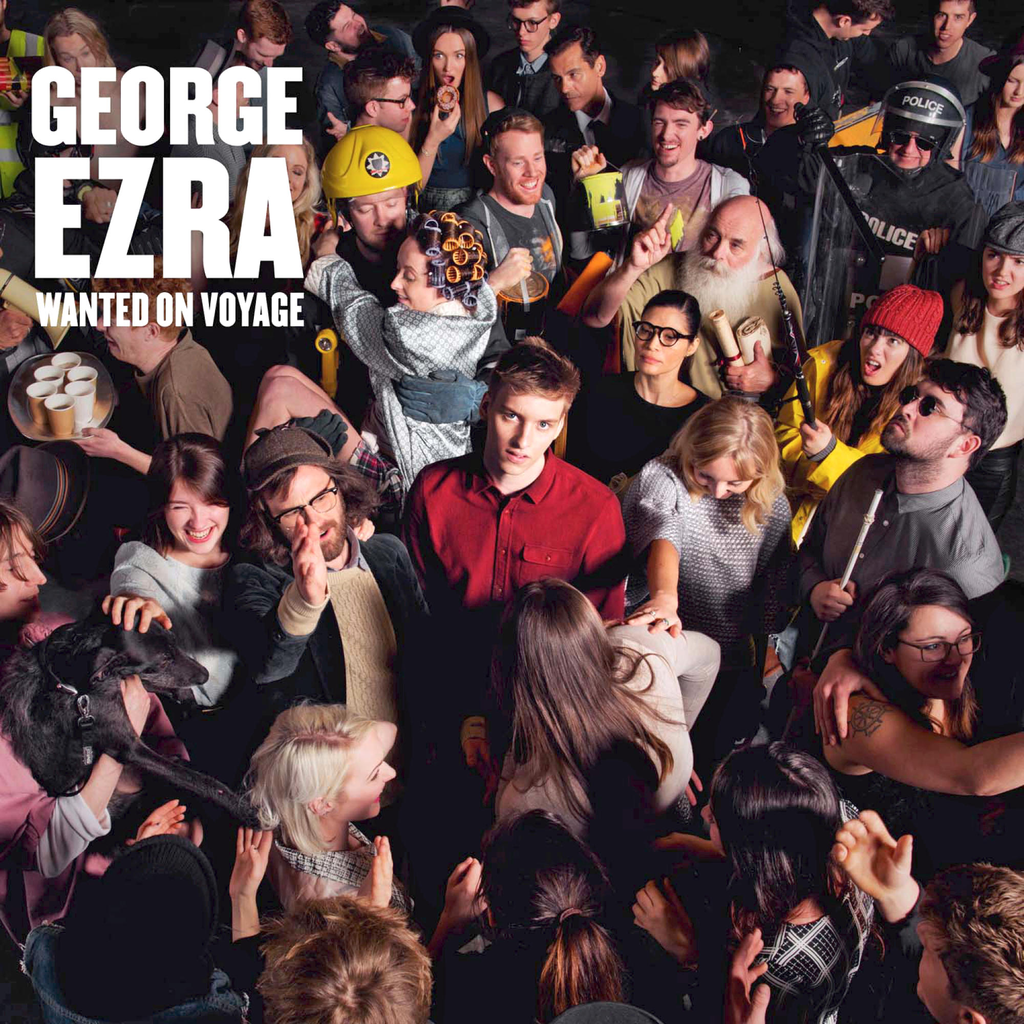 Albumcover mit einer Menschenmenge, einem Mann im roten Hemd und den Worten "George Ezra".