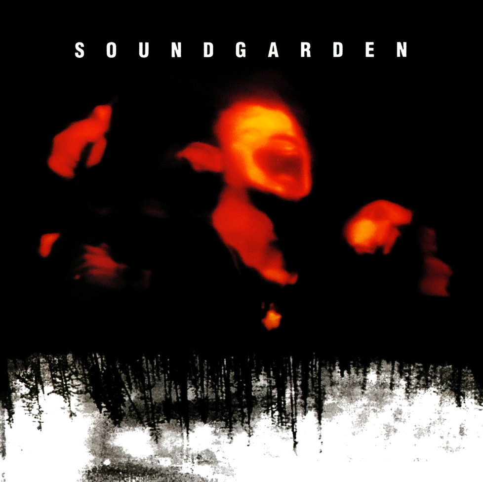 Soundgarden album borító. Piros, elmosódott arcok fekete háttér előtt. Erdő sziluettje alul.