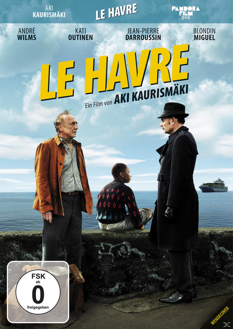 Filmplakat für Le Havre. Drei Personen am Meer. Zwei Männer, einer im Mantel, einer in einer orangefarbenen Jacke, ein Junge.