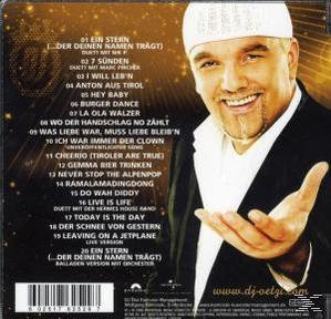 CD-Cover mit einem Mann mit weißer Kappe, der lächelt. Auf der linken Seite ist eine Liste der Songtitel sichtbar.