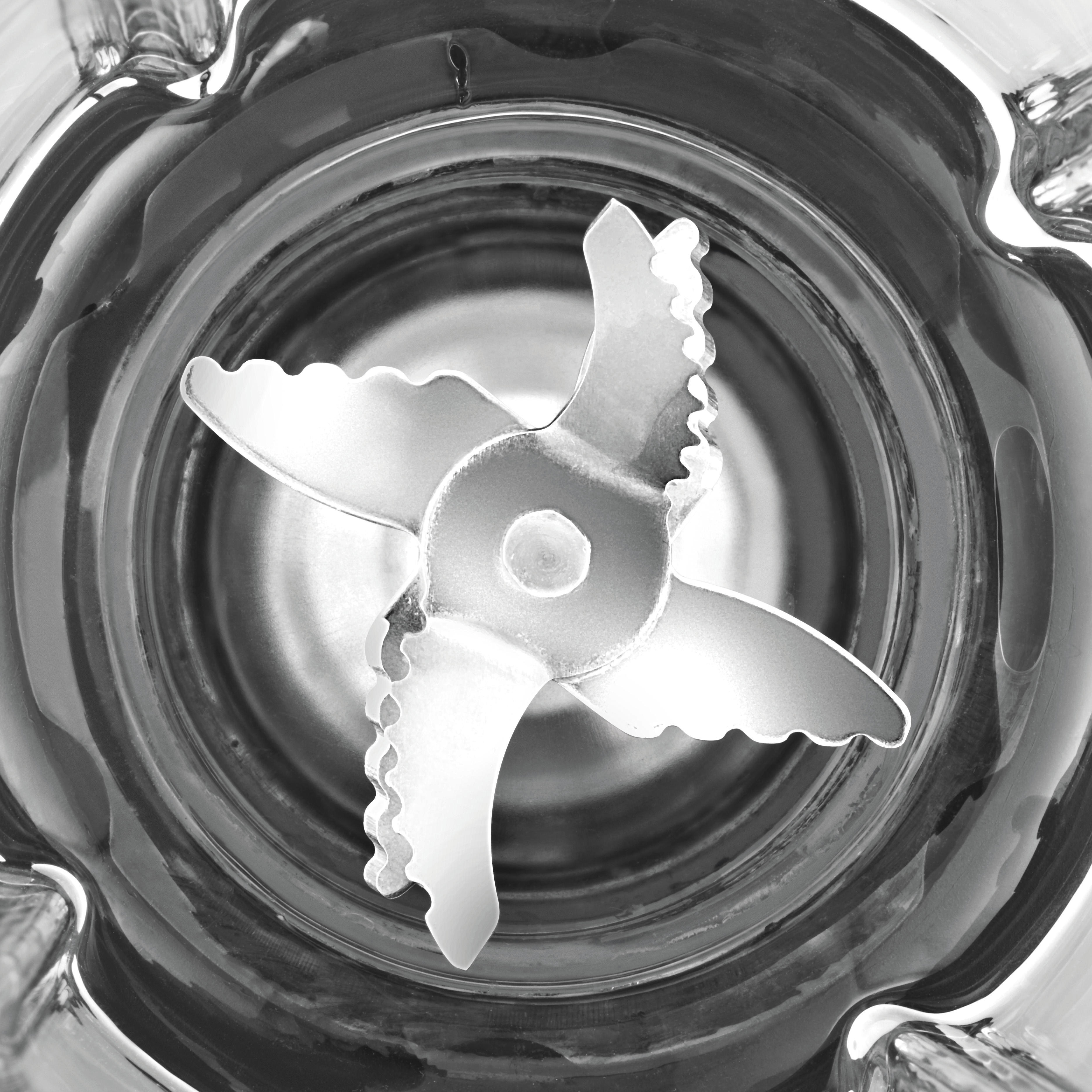 Top view of a blender's interior, showing blades inside a glass container.