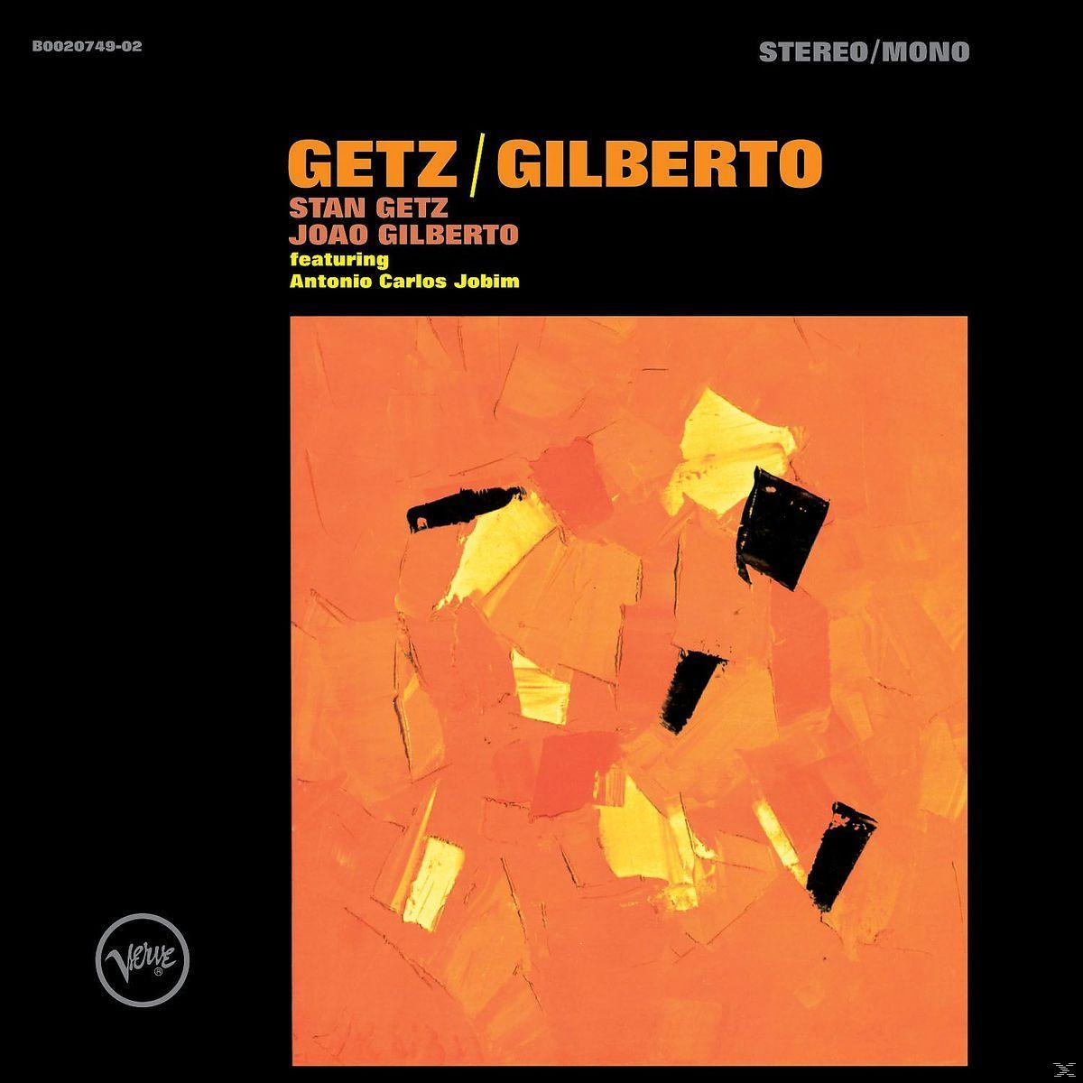 Albumcover mit abstrakten orangefarbenen Formen auf schwarzem Hintergrund. Text in Gelb.