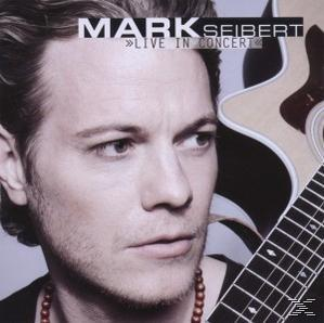 Mann mit Gitarre auf einem Albumcover.