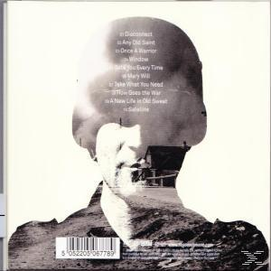 Album borító. Egy személy arca egy tájon. Tartalmaz egy szám listát a kép jobb oldalán.