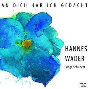 Eine blaue Blume mit weißem Hintergrund. Der Text 'Hannes Wader singt Schubert' steht neben der Blume.
