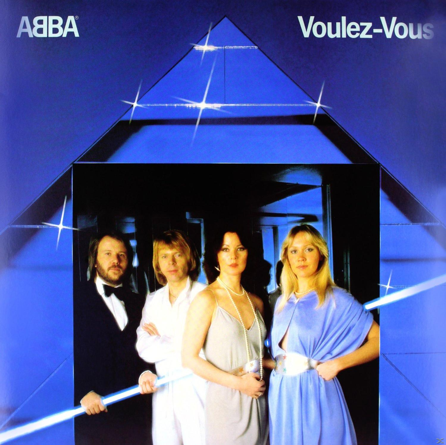 Albumcover mit vier Personen in einem blauen Dreieck, Titel 'Voulez-Vous' und Bandname 'ABBA'.