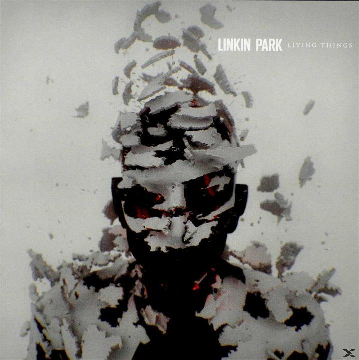 A Linkin Park 'Living Things' című albumának borítója. Egy összetört arcú figura, fehér háttérrel.