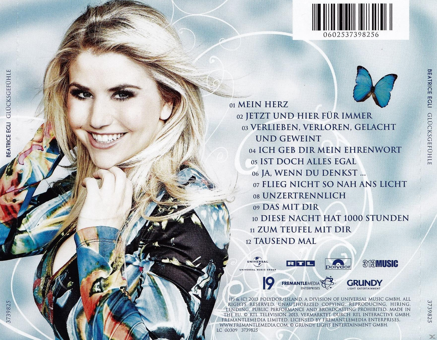 Beatrice Egli Albumcover. Lächeln Frau, Text, blauer Schmetterling, und Titelliste.
