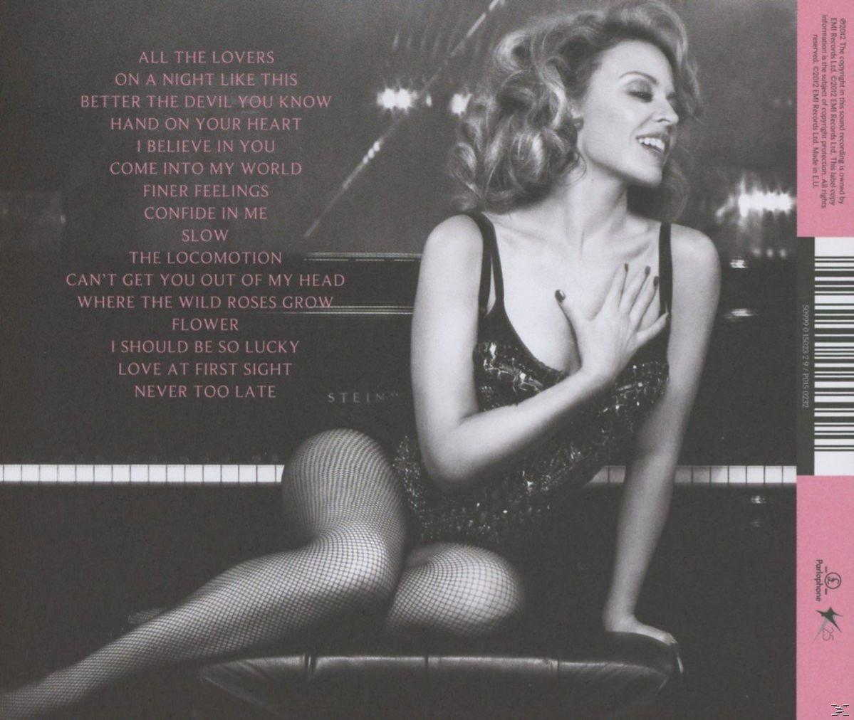 Albumcover mit Kylie Minogue, Text: Stein, Albumtracks und einem Klavier.