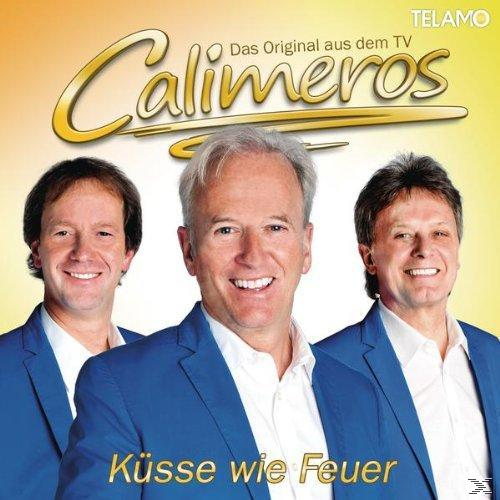 Albumcover von Calimeros mit drei Männern in blauen Anzügen, mit dem Text „Küsse wie Feuer“.
