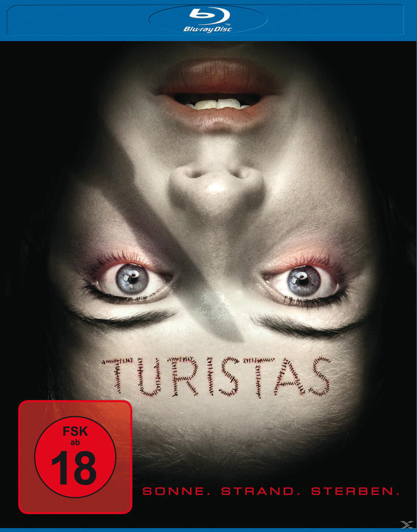Blu-ray-Cover: Auf dem Kopf stehendes Gesicht mit offenen Augen, Text und Rating-Logo auf schwarzem Hintergrund.