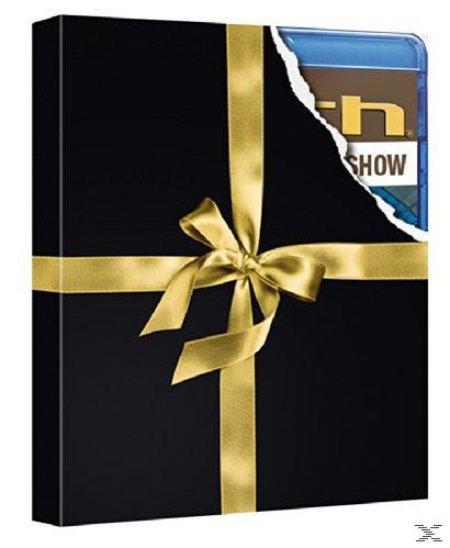 Schwarze Geschenkbox mit goldenem Band und Schleife, mit einer Ecke, die eine Blu-ray Disc zeigt.