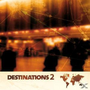 Albumcover: Verschwommenes Bild eines Flughafens oder Bahnhofs, mit Silhouetten und Orangetönen.