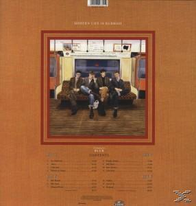 Vier Männer in einem U-Bahn-Innenraum, Albumcover. Der Hintergrund ist ein braunes Albumcover.
