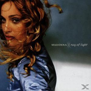 Album borító Madonna-val, hullámos hajjal és kék szatén felsővel, szürke háttér előtt.