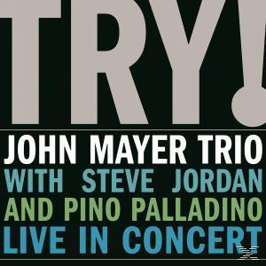 A John Mayer Trio 'Try!' című albumának borítója. Vastag fehér szöveg fekete háttéren. A zenekar neve és a 'Live in Concert'.