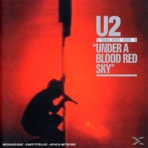 U2-Albumcover. Eine Silhouette kniet mit Mikrofon vor rotem Hintergrund und Text.