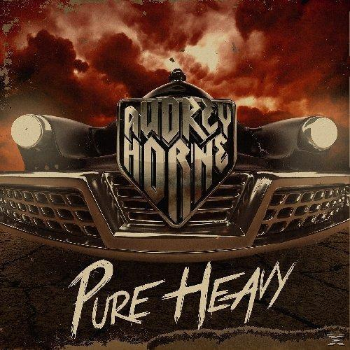 Albumcover mit Autovorderseite, Bandname und den Worten 'Pure Heavy' auf rotem Himmel.