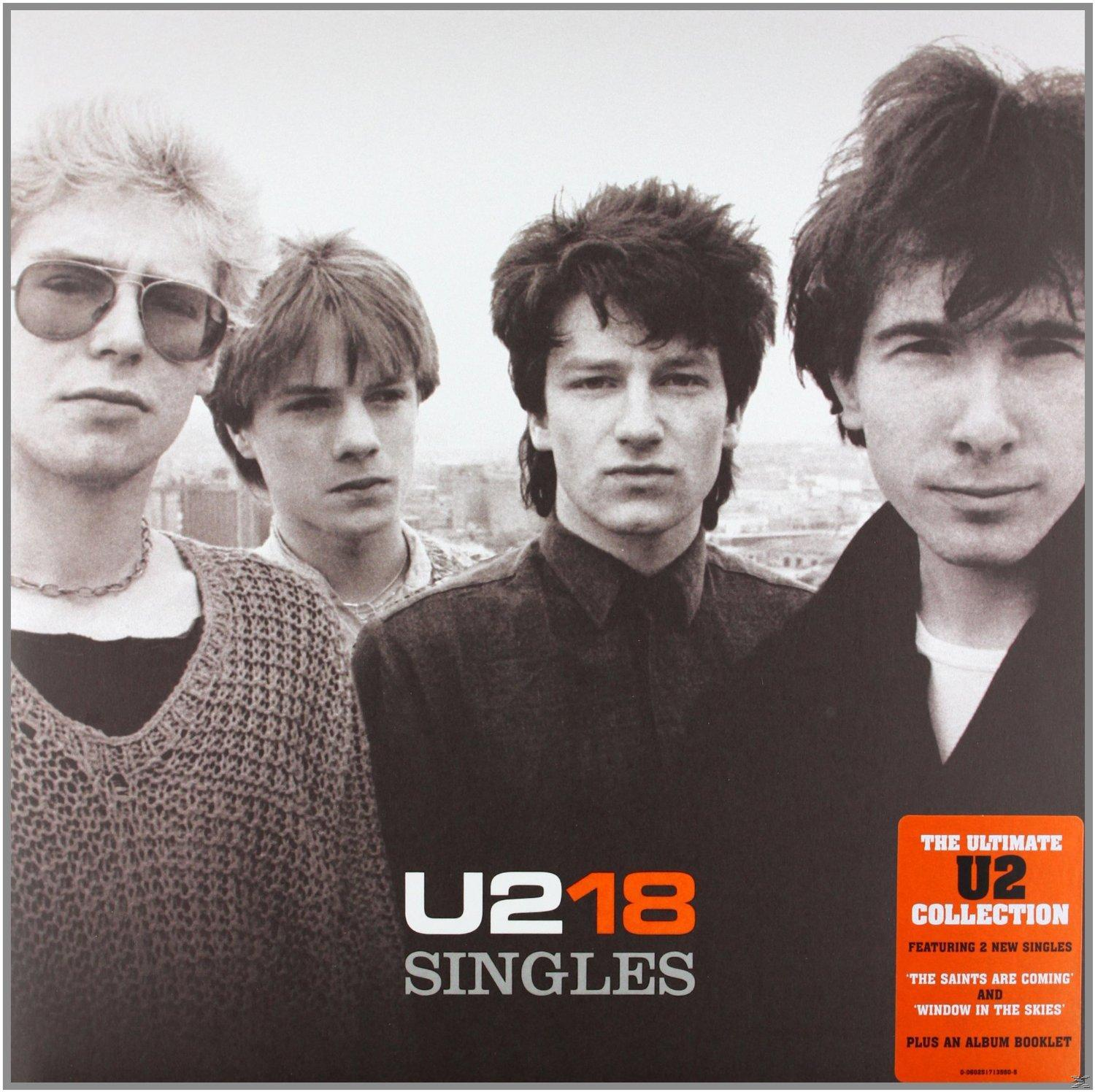 U2-Albumcover, vier Bandmitglieder, Text U2 18 Singles.