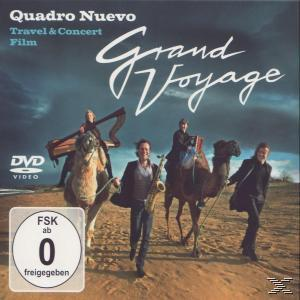 CD-Cover: Musiker auf Kamelen, Titel 'Grand Voyage'. Hintergrund: Wüstenlandschaft mit stürmischem Himmel. DVD- und FSK-Logo.