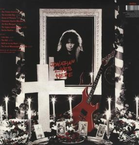 Albumrückseite. Ein Mann in einem Rahmen. Kreuz und Gitarre. Schwarzer Hintergrund.