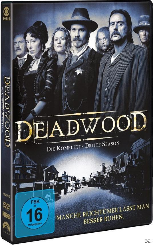 DVD-Cover. Gruppe von Leuten in alten Kostümen. Der Titel lautet Deadwood. Die Wörter sind auf dem Cover.