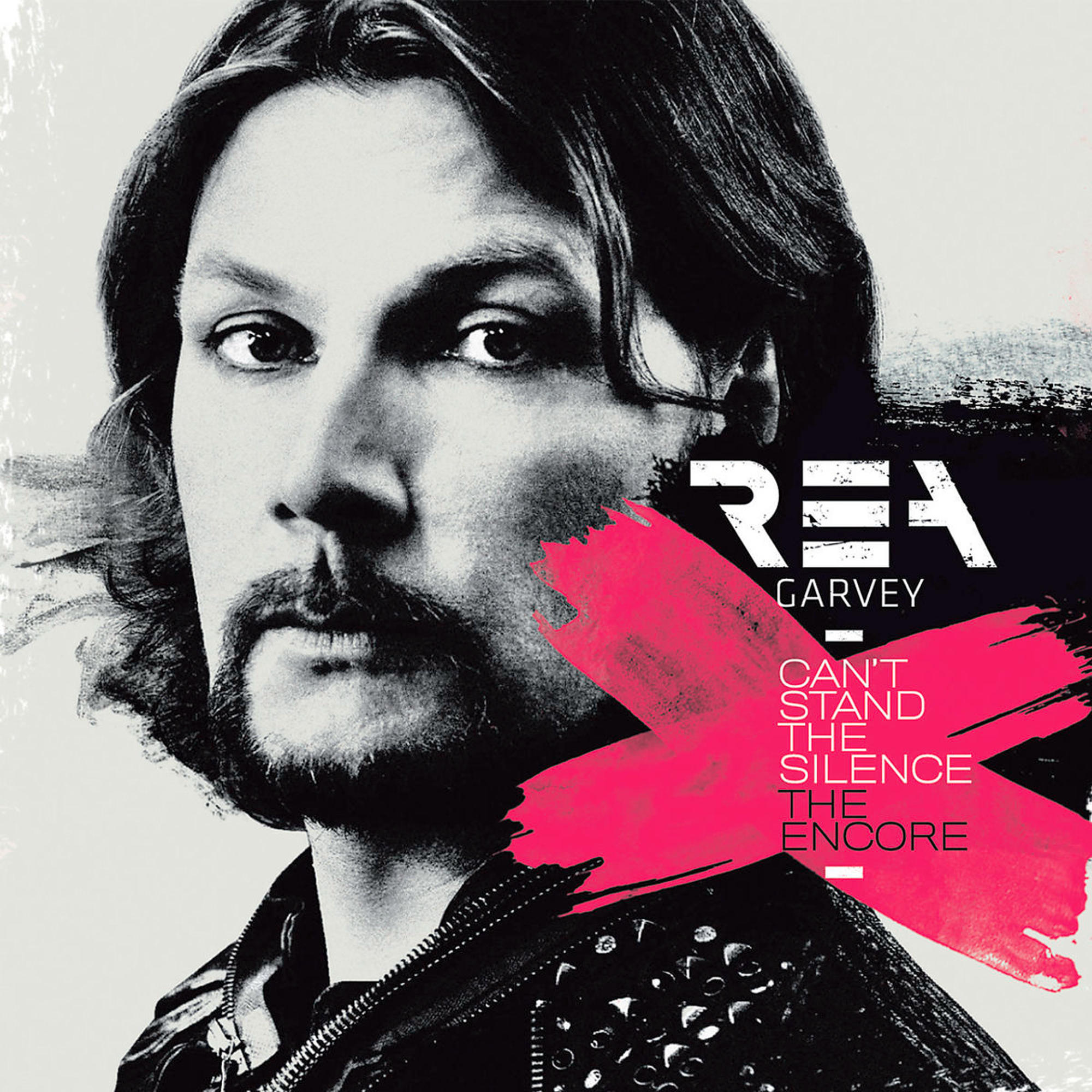 Rea Garvey Albumcover. Das Gesicht eines Mannes steht im Vordergrund. Text in Pink und Schwarz.