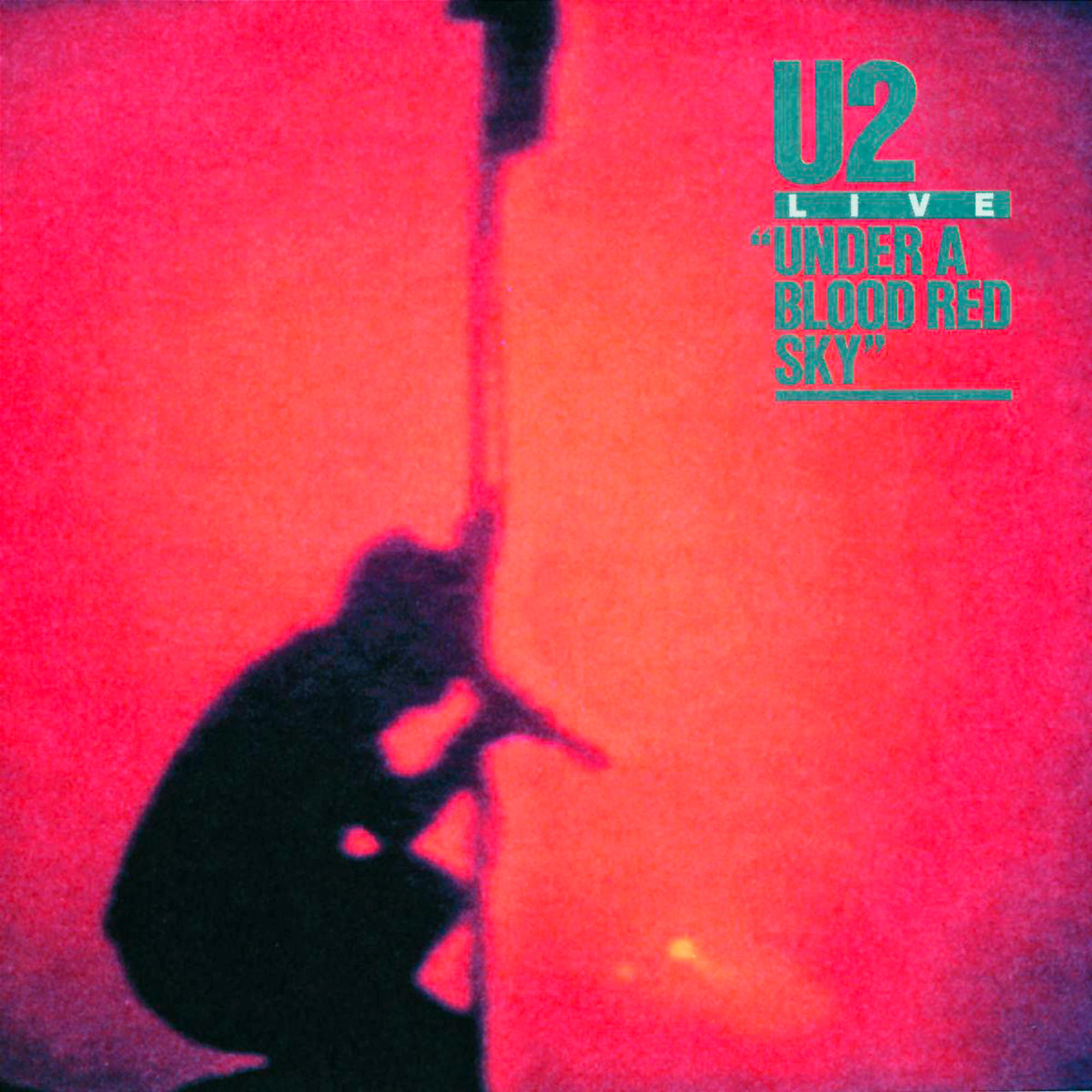 Ein rotes Bild mit einer dunklen Figur und Text. U2 Live 'Under a Blood Red Sky'.