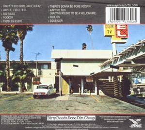Albumcover mit einer Straßenszene mit einem Gebäude, Palmen und einem Auto. Text oben.
