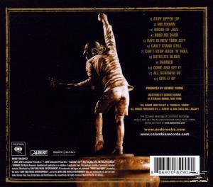 Albumcover mit Statue, Trackliste und Albuminfo mit dunklem Hintergrund.