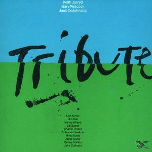 Album borító a 'Tribute' szóval nagy fekete betűkkel zöld és kék háttéren.