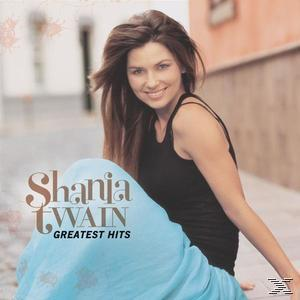 Album borító. Hosszú barna hajú nő fekete felsőben és kék szoknyában. Cím: Shania Twain, Greatest Hits.