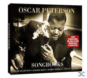 Az Oscar Peterson Songbooks album borítója. Peterson pipázik, szöveg és egy piros matrica látható.