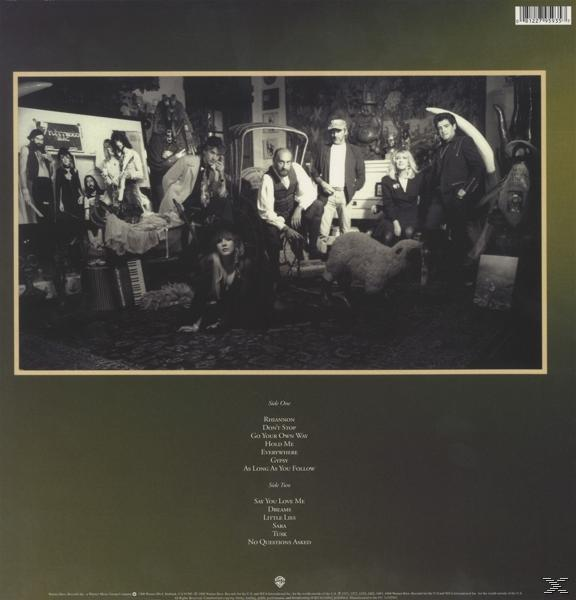 Dos de l'album. Groupe de personnes dans une pièce avec des objets. Liste des titres à gauche.