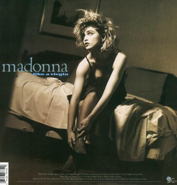 Madonna auf dem Like a Virgin Albumcover. Sie sitzt auf einem Bett und schaut zur Seite. Dunkler Raum, Sepiatöne.