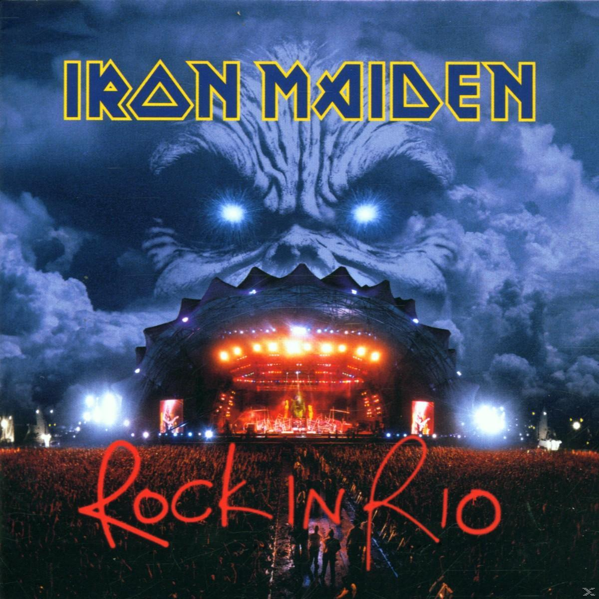 Iron Maiden Rock in Rio album borító. Világító színpad, tömeg, szörnyeteg arc a háttérben, a zenekar neve és a Rock in Rio szöveg.
