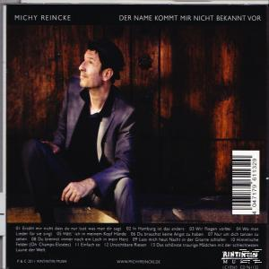 Albumcover für Michy Reincke. Ein Mann sitzt, mit dunklem Hintergrund und Titelliste.